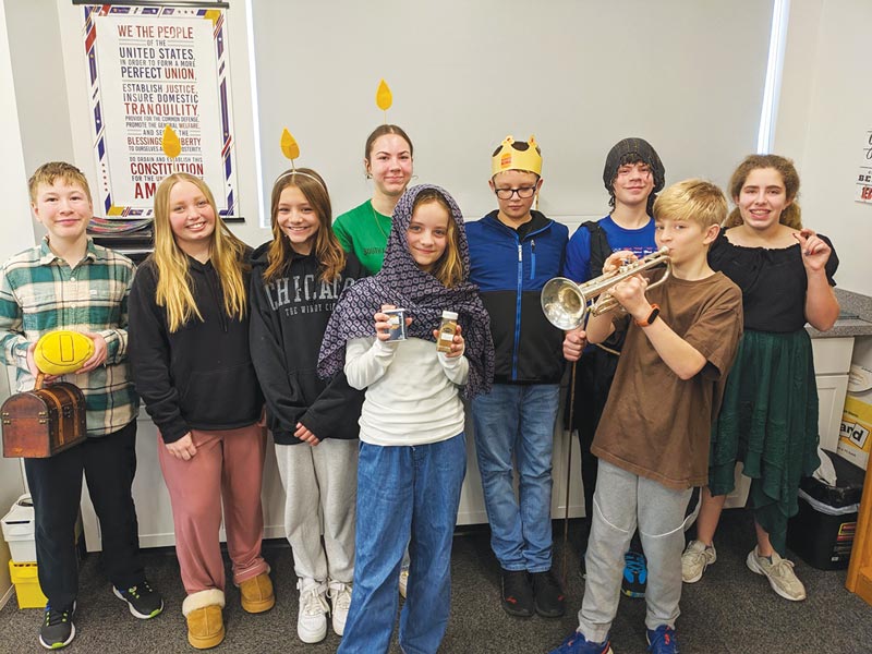 young teens posing for photo. boy with trumpet and crown and candles