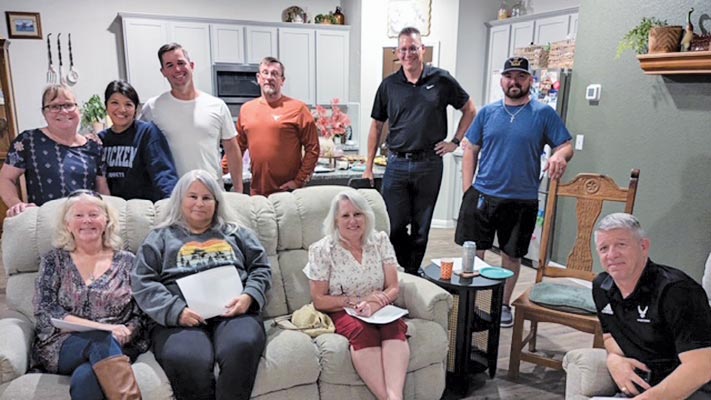 group of people in a house posing home missions