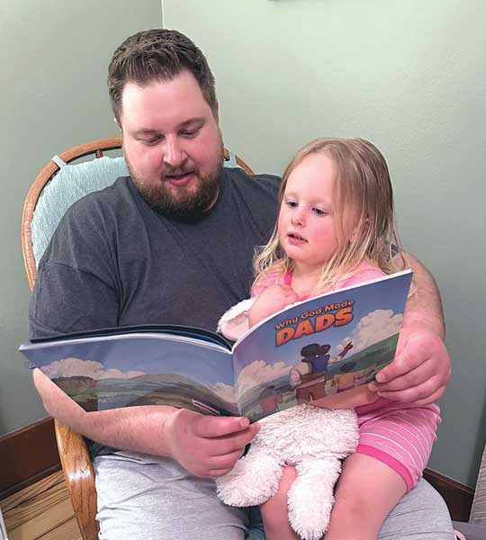 dad reading book todaughter