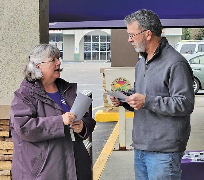 woman and man talking purple jacket
