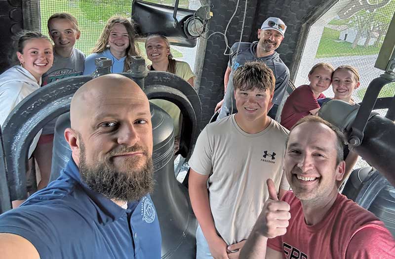 group of teenagers and dads at bell tower