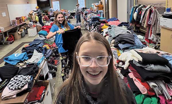 teen girls organizing clothing
