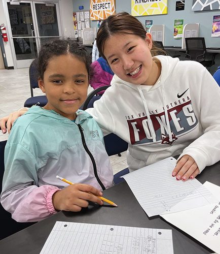 teen and young girl doing math homework