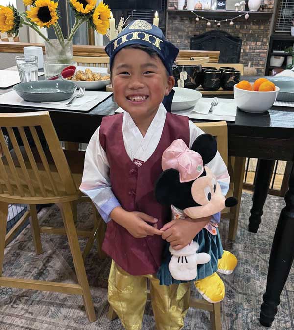 young boy, korean holding mickey mouse stuffed animal
