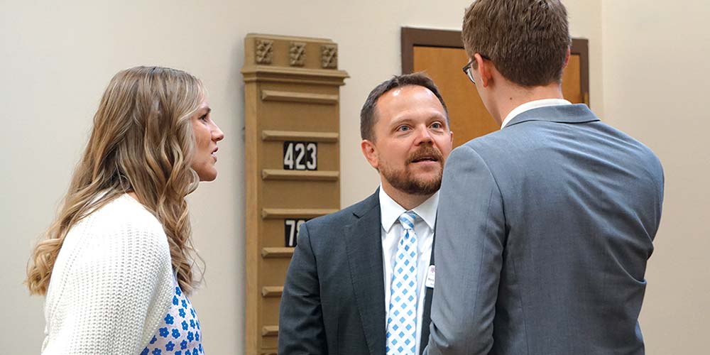 Michael Seifert, Joshua Wordell and his wife having a talk white tie with diamonds