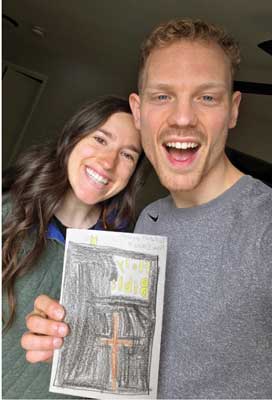 Man and woman holding up a homemade card