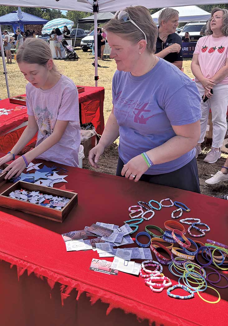 selling rubber bracelets under tent Strawberry Festival.