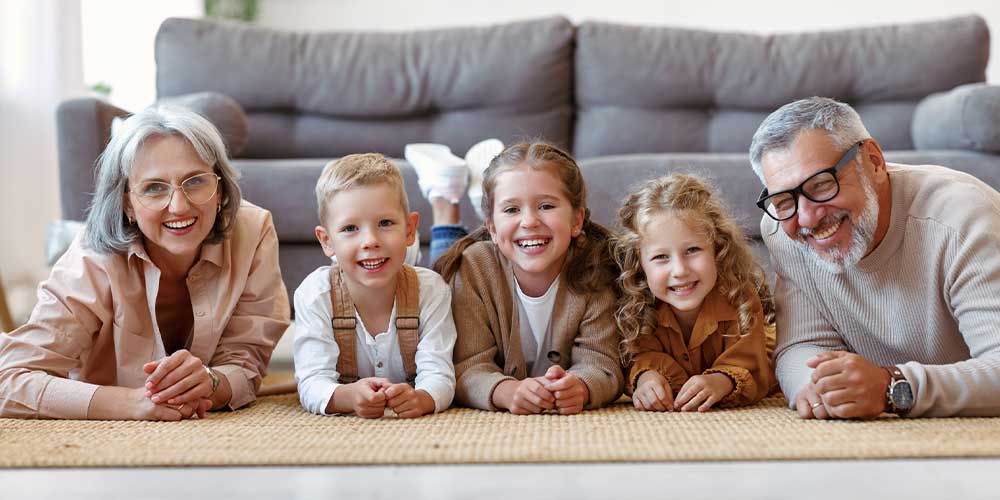 grandma and grandpa on the ground with grandkids