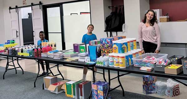 back to school drive and kids by the tables