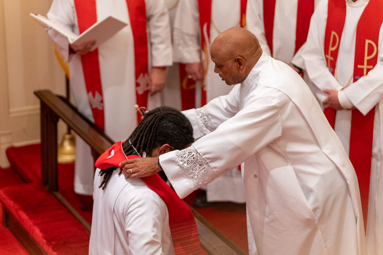 Raymond Kimbrough placing his stole on Keri Jackson during Jackson's ordination