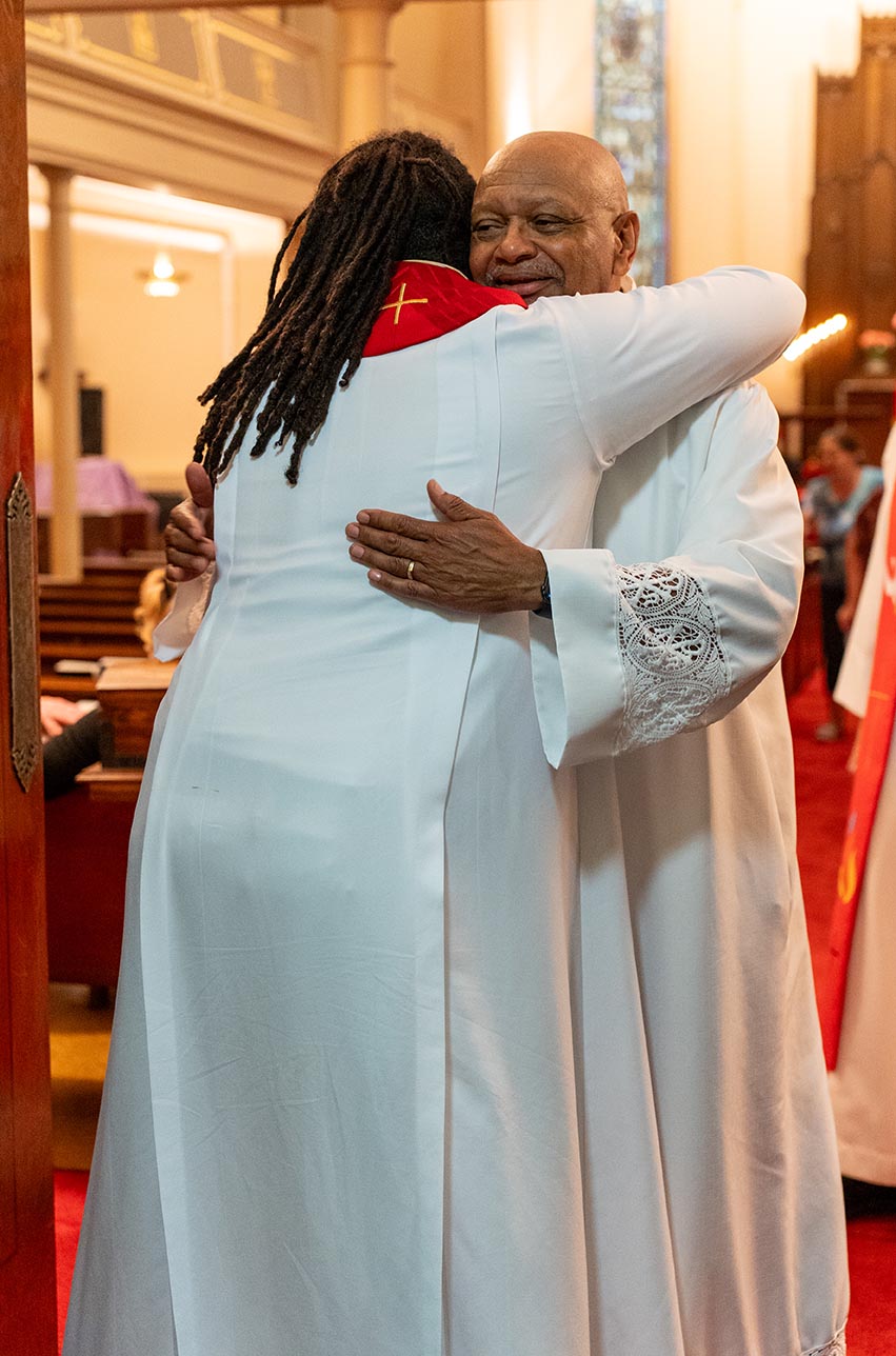Keri Jackson and Raymond Kimbrough hugging after Keri's ordination
