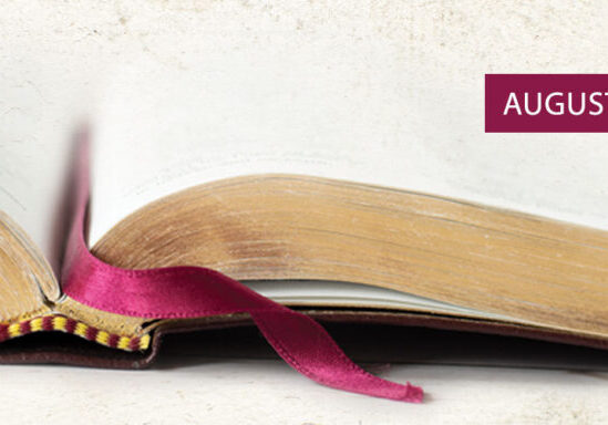 close up of open bible with gold on outside and maroon ribbon