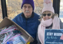 stay warm giveaway of hats man and woman in bus stop