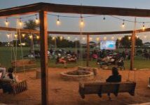 outdoor swings and firepit with movie playing
