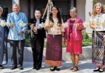 Thai Village opened and dedicated a new training facility woman and men waiting to cut the ribbon